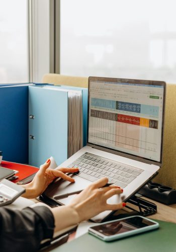 Business workspace with folders and laptop showing analytics screen. Ideal for tech and work themes.